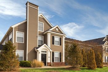 Exterior with brown siding and blue skies in the background